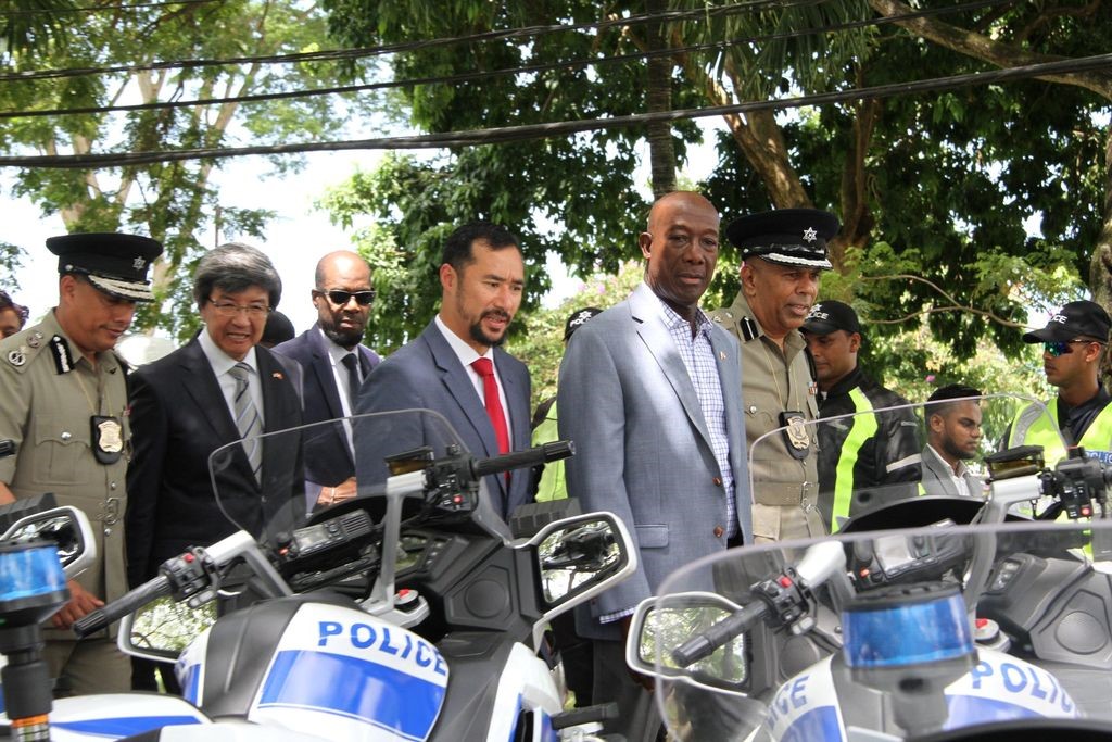 Prime Minister Dr Keith Rowley and National Security Minister Stuart Young at a                      ceremony to hand over motorcycles given to the Trinidad and Tobago Police Service by the     People's Republic of China, at the Police Academy in St James, Port of Spain on Wednesday August 21, 2019. Photo courtesy the Office of the Prime Minister.
