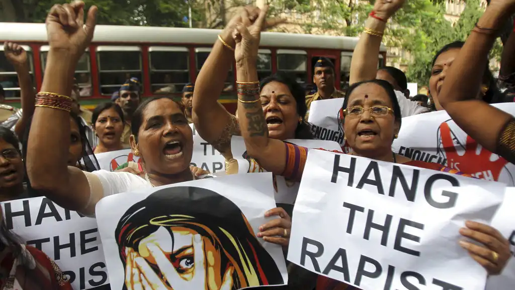 FILE - In this Aug 23, 2013 file photo, Indian activists hold placards demanding rapists be hanged as they protest against the gang rape of a 22-year-old woman photojournalist in Mumbai India. (AP Photo/Rafiq Maqbool, File)